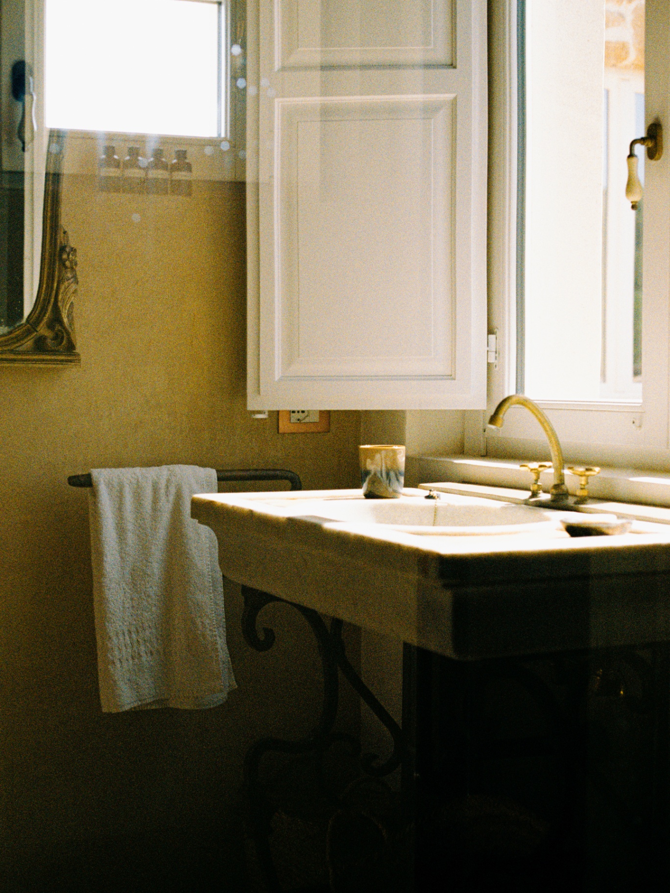 Soft film light on a marble bathroom sink and linen towel