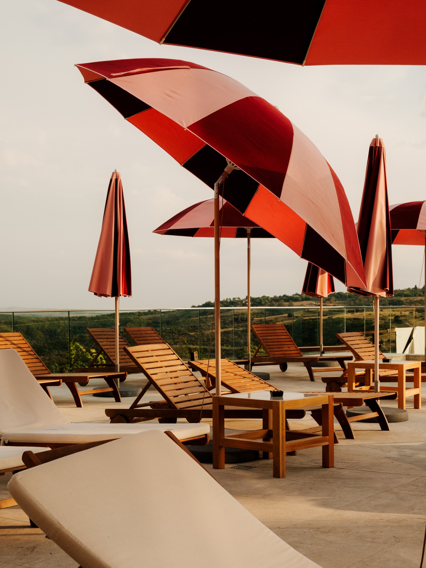 Rooftop terrace with red umbrellas at Hotel Bodbe, Georgia