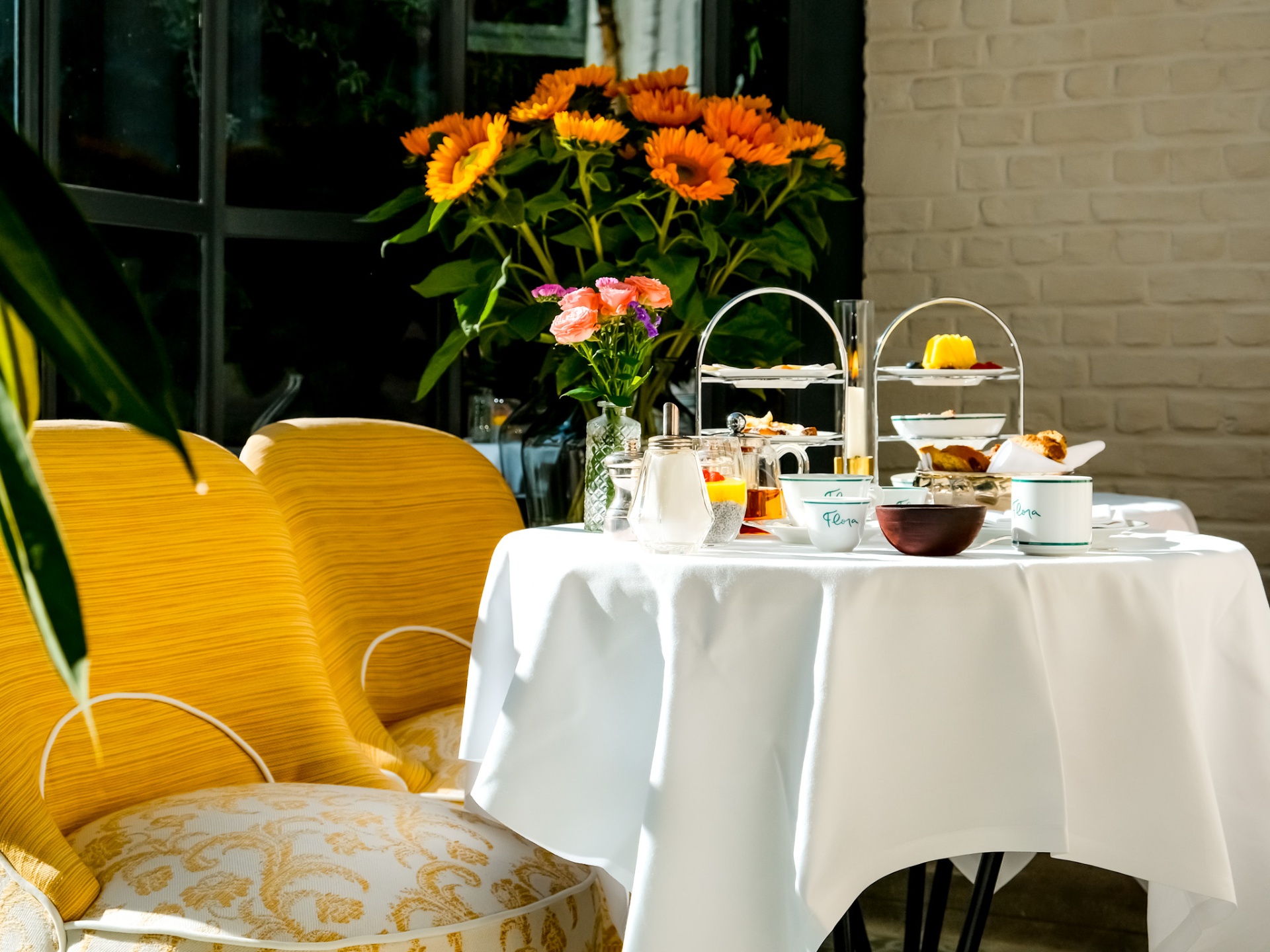 Afternoon tea set with sunflowers and yellow velvet chairs