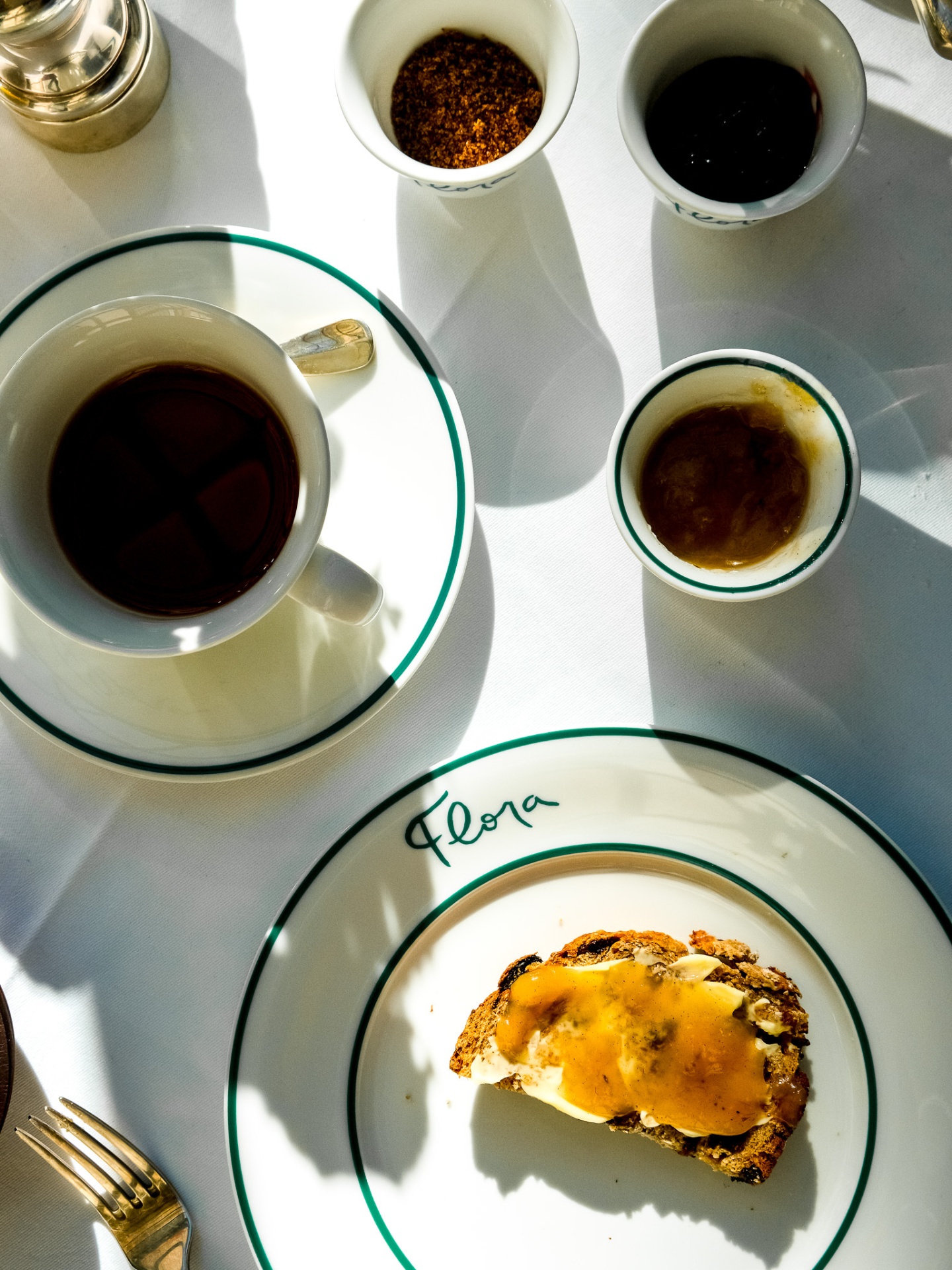 Overhead espresso cup and toast on Flora-monogrammed china