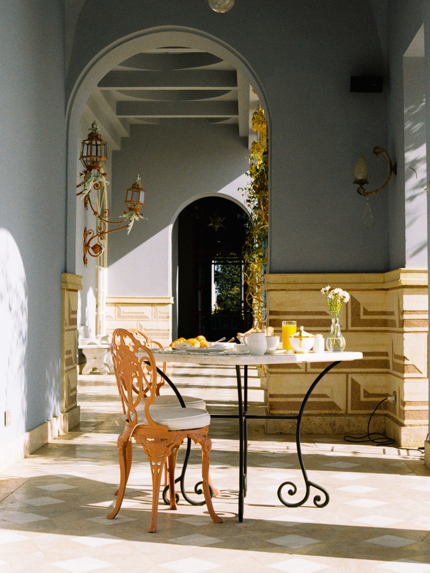 Breakfast for one on a sunlit arched terrace