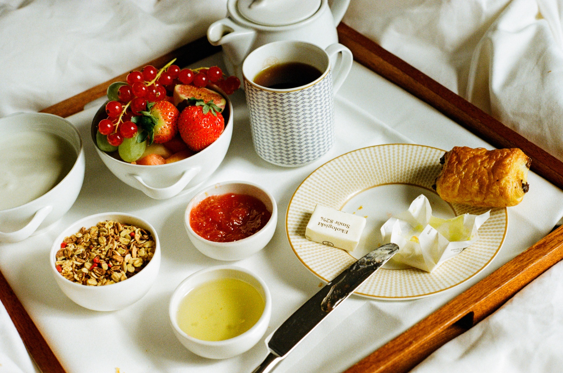 Overhead view of a full Norwegian breakfast tray with coffee and pastries