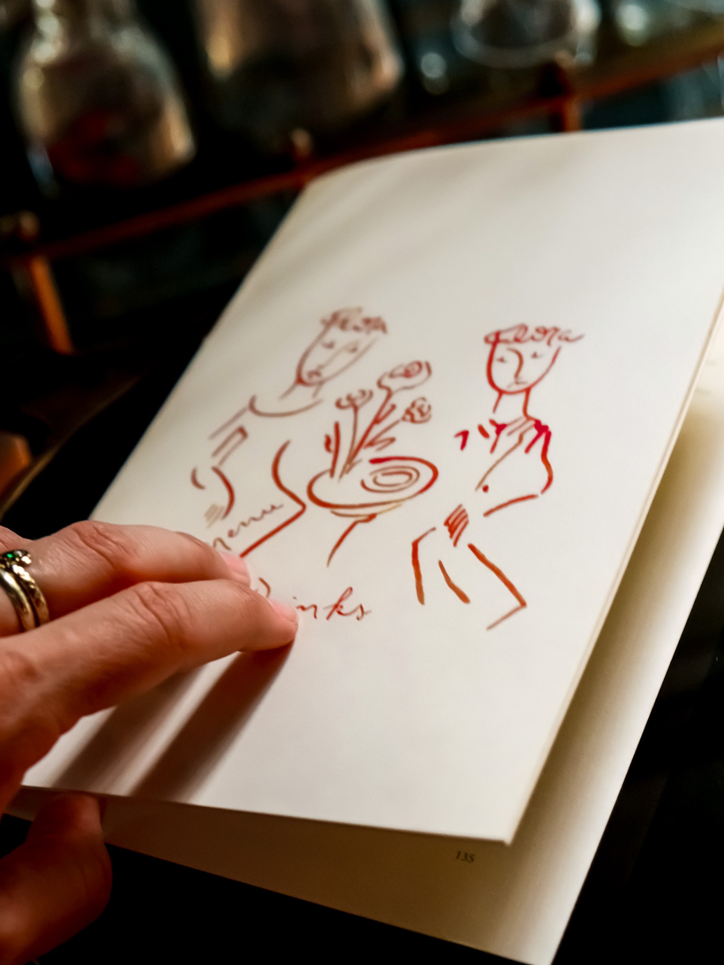 Hand-drawn red ink illustration in a Flora menu