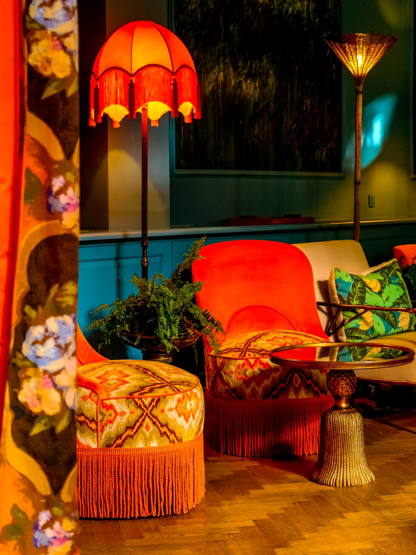 Fringed orange floor lamp glowing in a moody salon