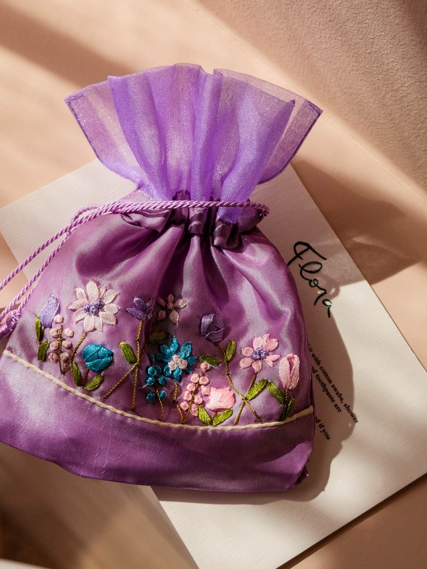 Embroidered organza pouch on a Flora card